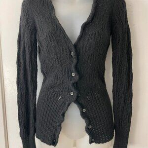 Black ribbed cardigan with button-up front and ruffle details